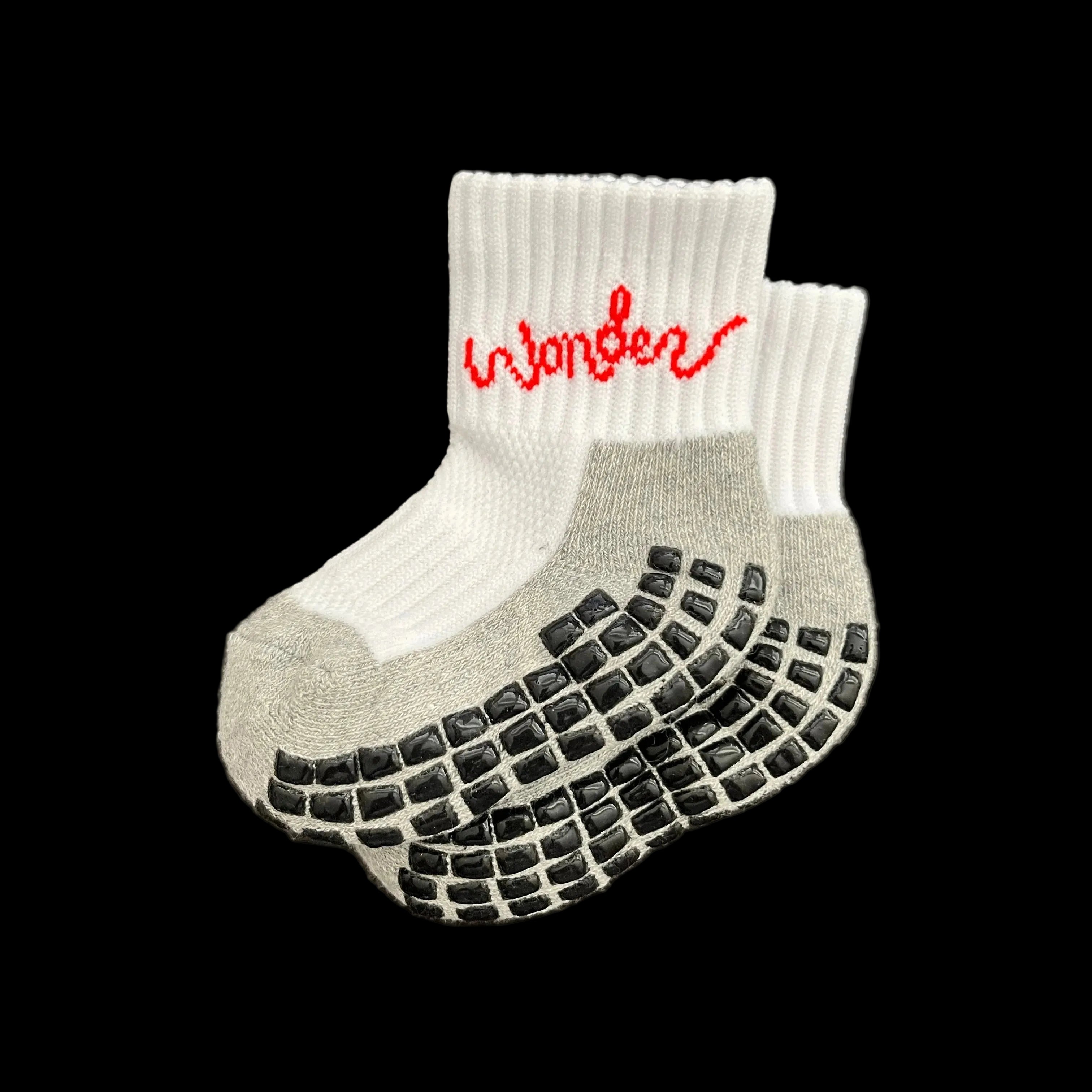 A pair of white and gray anti-slip compression socks with red text 'wonder' on the ankle area.