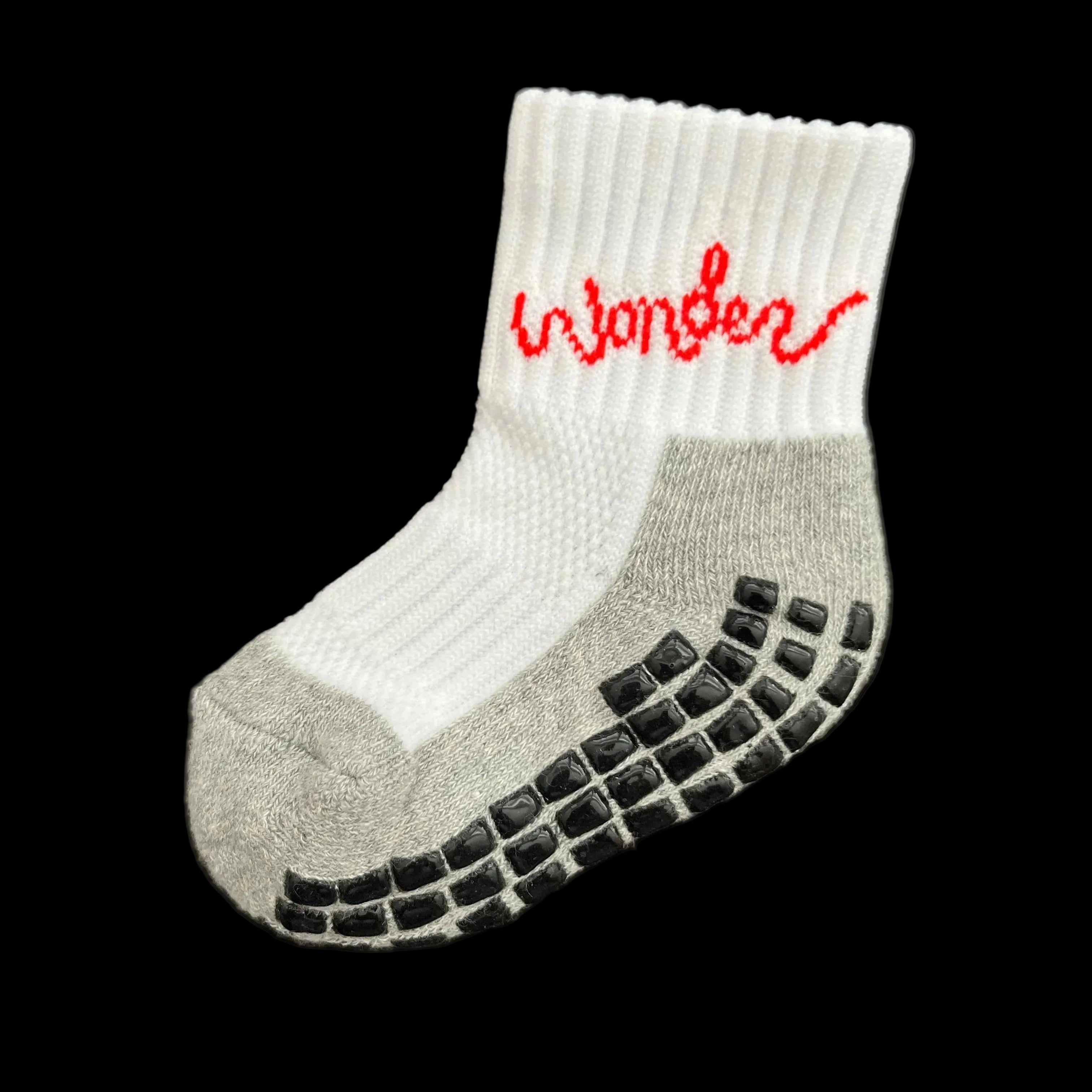 out side of sock view, white sock, grey sole, antislip rubber grips black in color on bottom of sock