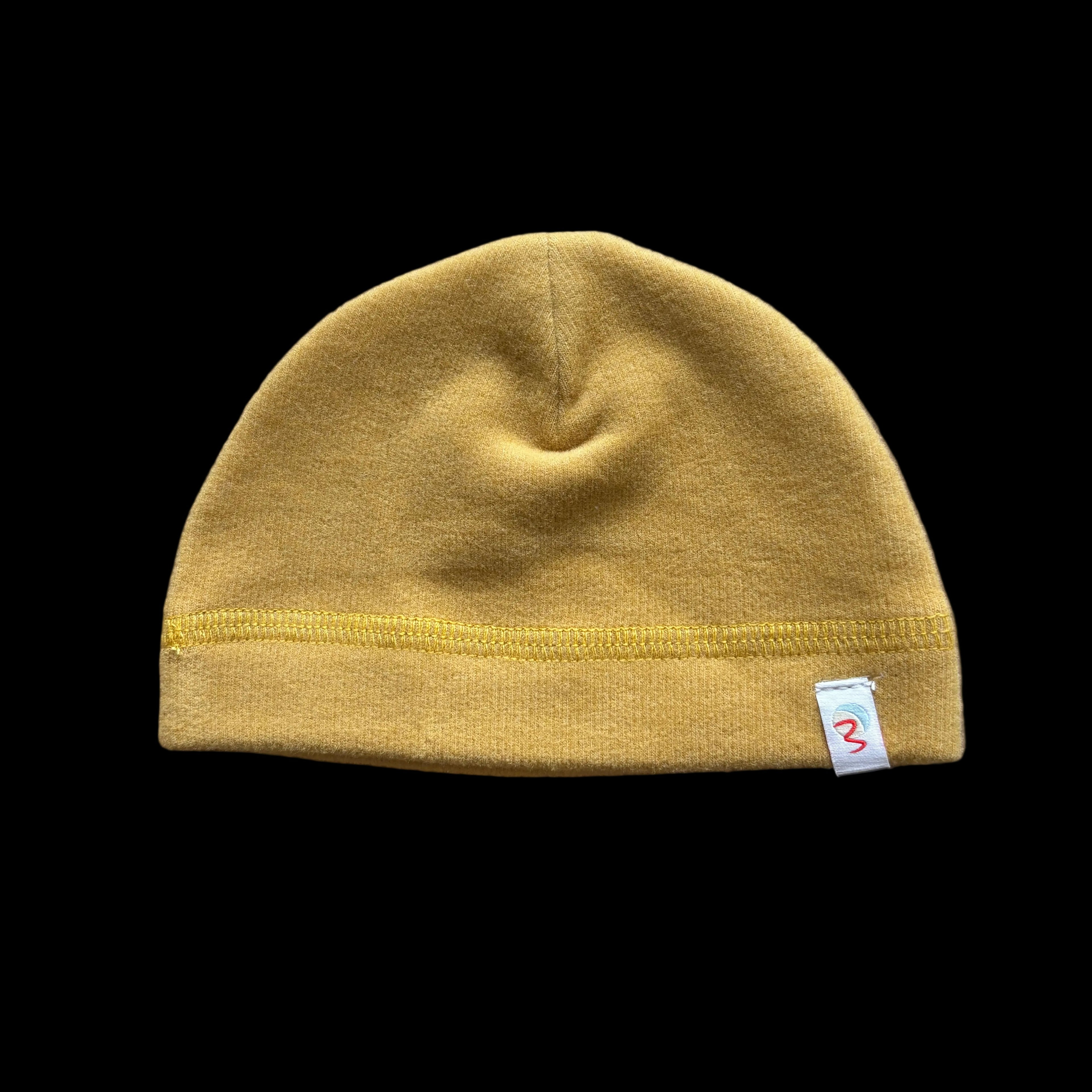 Yellow beanie with a brand logo on a black background