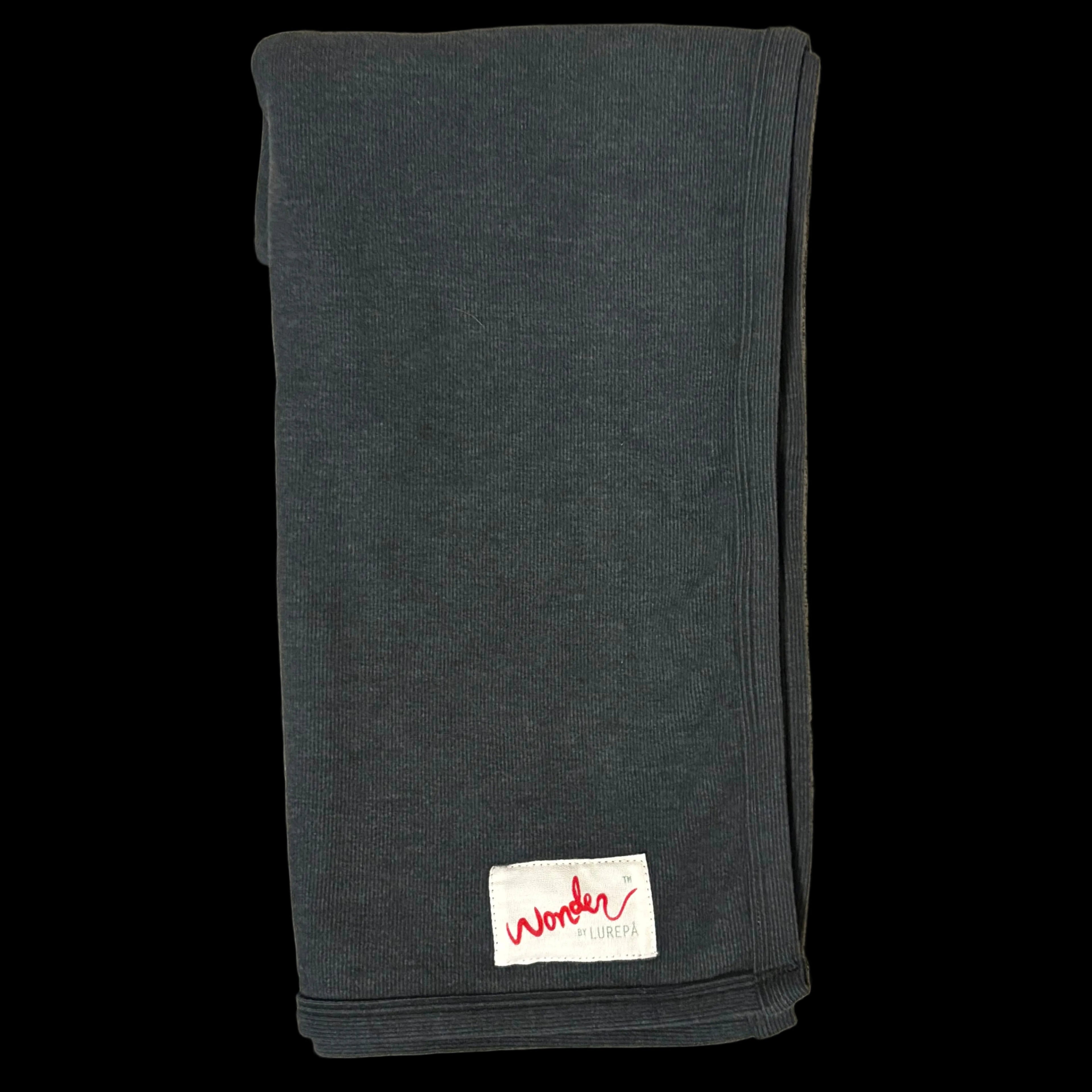 Folded green blanket with a visible brand label 