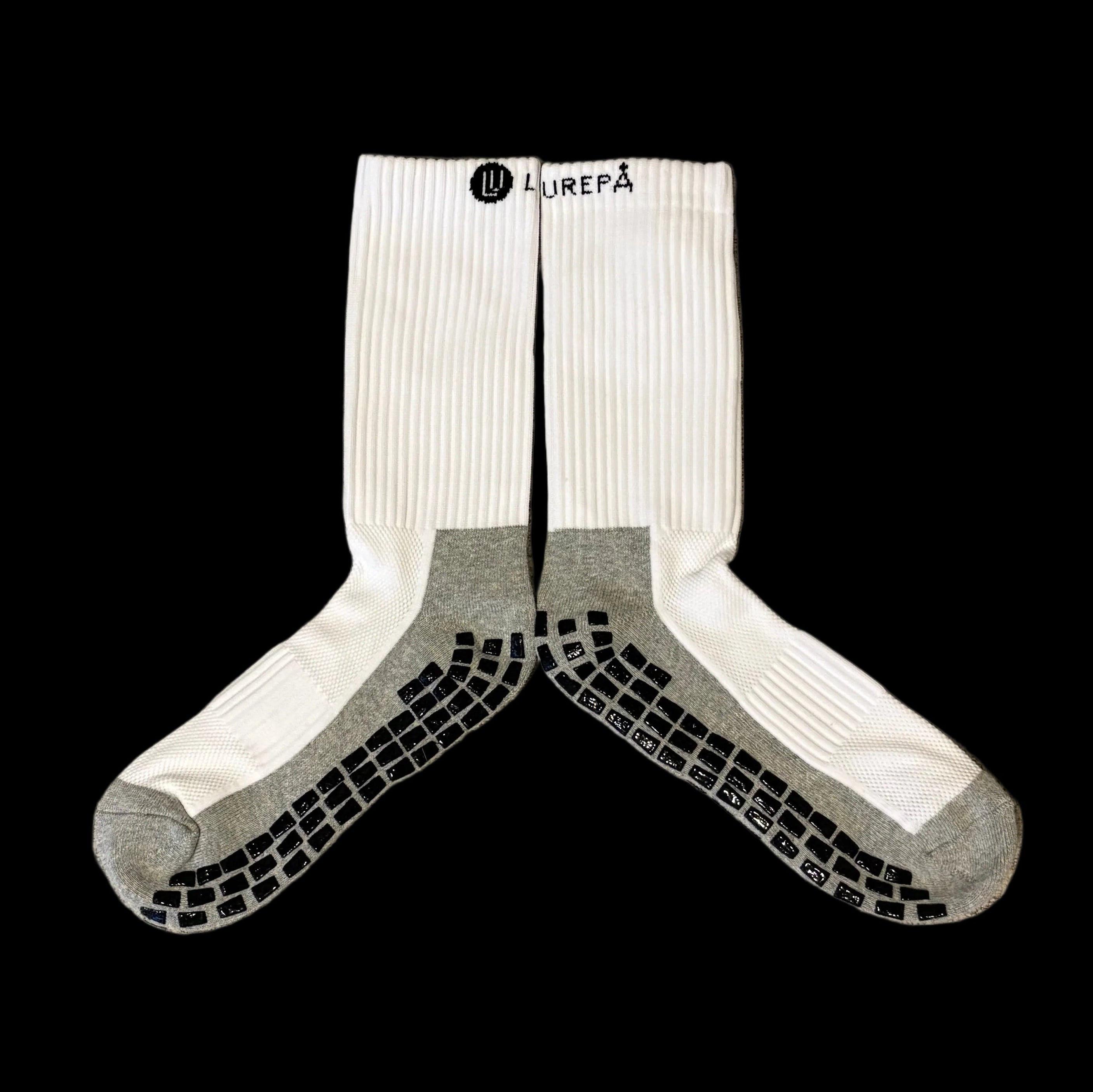 White sock with black text of brand, grey soles and black anti slip grips on soles
